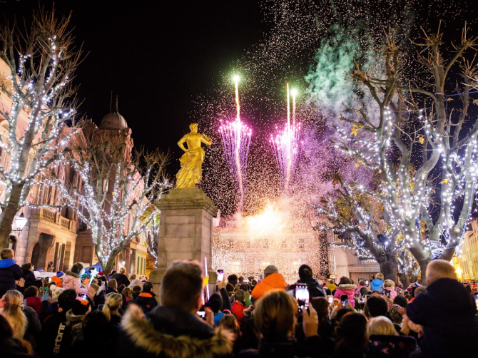 Crowd celebrating Christmas with fireworks in St Helier