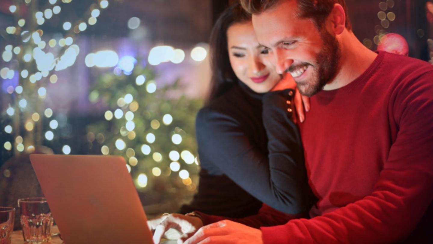 Young couple using a laptop at Christmas time
